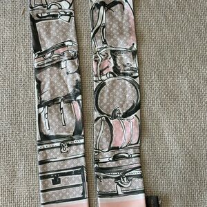 Louis Vuitton Trunks Bandeau, a signature silk scarf accessory.